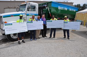 Safety Award recipients (left to right), Al Perry, Terry Preston, Eddie Anderson, Peyton Padmore, and Division Manager, Bob Wolk, stand in front of new compressed natural gas powered roll-off truck at the Doraville Regional Office.